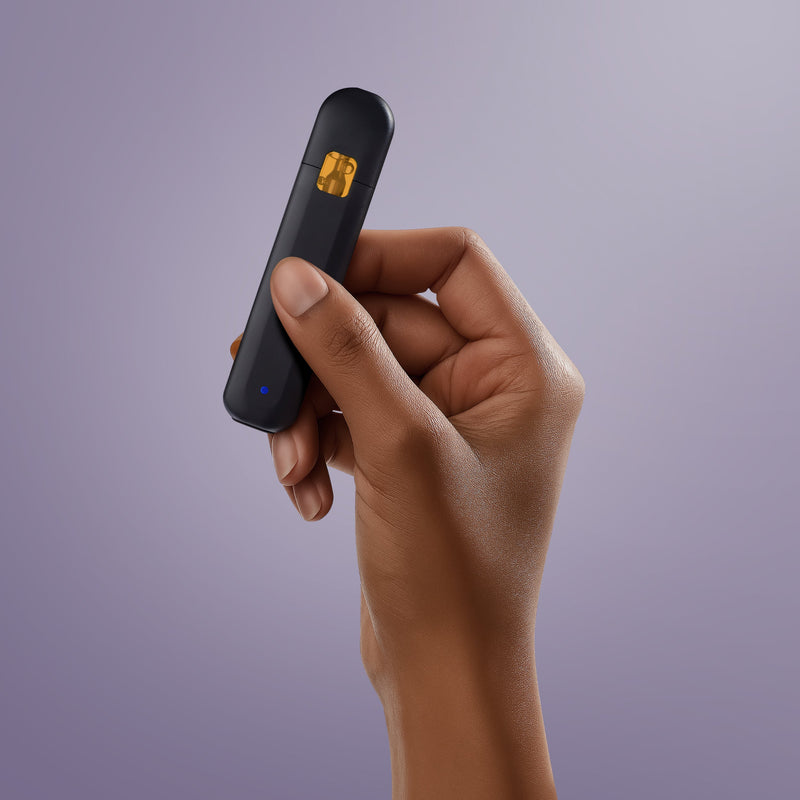 Close-up of a hand holding Secret Nature’s CBD disposable vape pen with sleek black design.